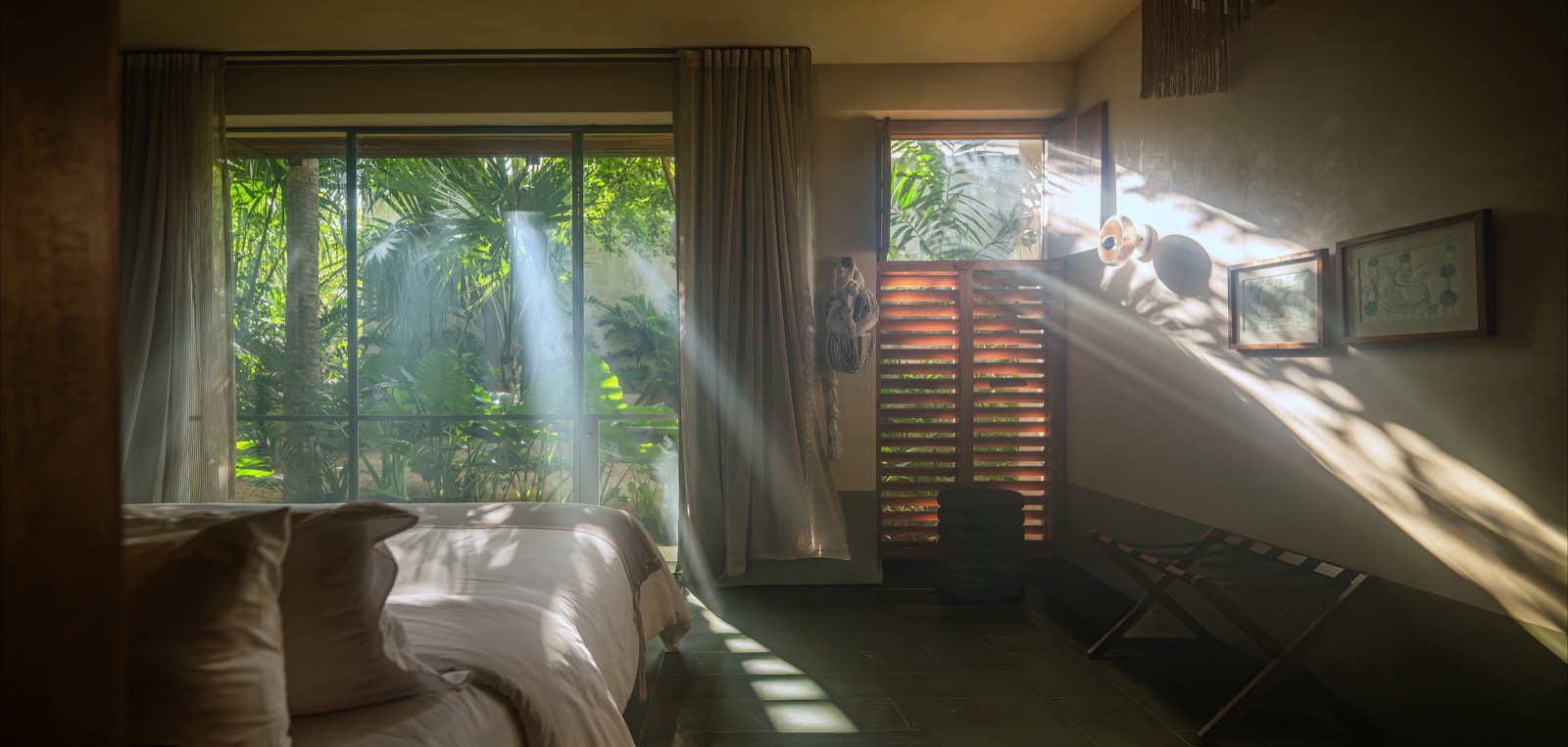 Morning light through the curtains of a garden-facing bedroom
